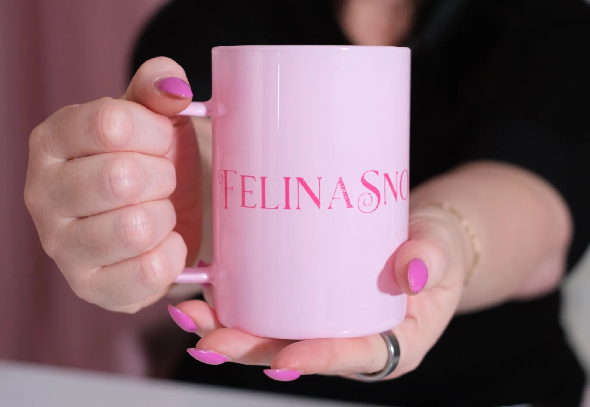 A branded Felina Sno Wellness mug